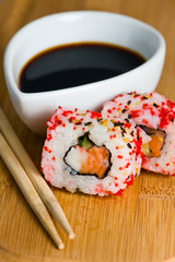 sushi in row on bamboo mat