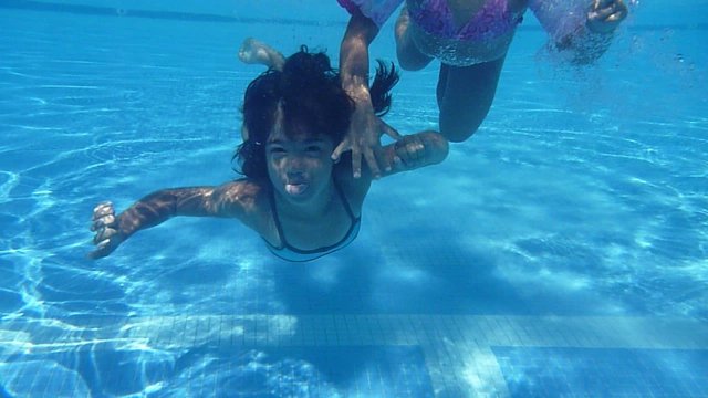 girls swimming in the pool