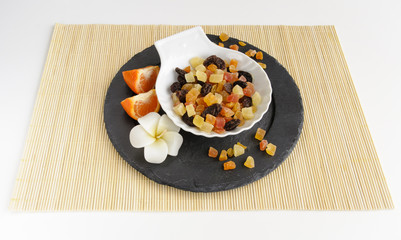 Dried fruits on stone plate with flower