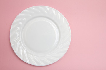 white plate on a pink background