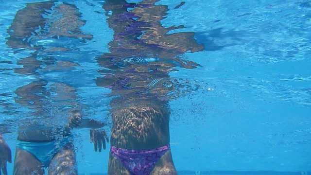 cute girls playing in the pool