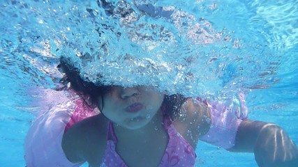 cute girl playing in the pool