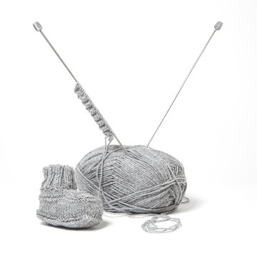 A little bootie by a knitting equipment