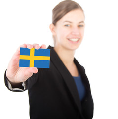 business woman holding a card with the Swedish flag