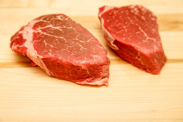 Two Filet Mignon Steaks on Wood Cutting Board