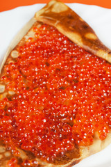 Pancake with red caviar