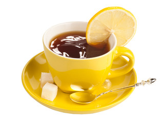 Yellow teacup with sugar and lemon.