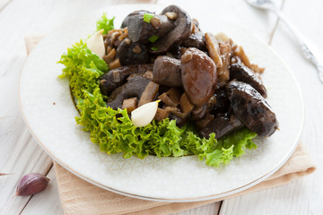 boletus fried with vegetables on a white plate