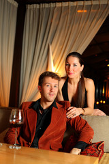 portrait of man who sits and beautiful girl standing near