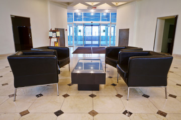 Reception hall with leather armchairs in business center
