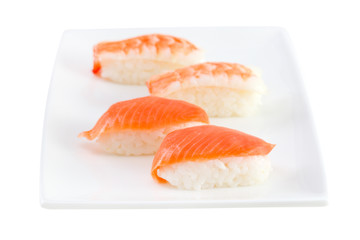 sushi with salmon on the plate on white background