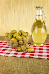 olives with a bottle of olive oil