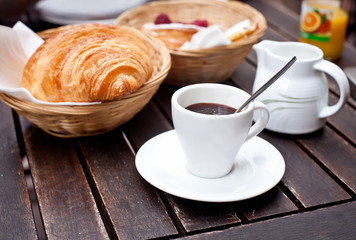 A Cup of Coffee with a Croissant and Milk at Cafe