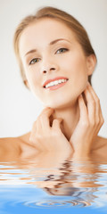 face and hands of beautiful woman in water