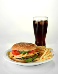 Tasty cheeseburger with fried potatoes and cold drink, isolated