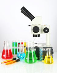 Test tubes with colorful liquids and microscope isolated