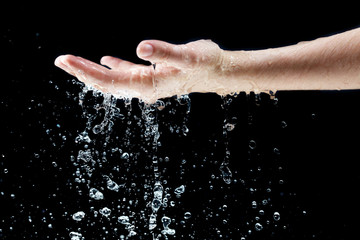 Fototapeta premium Water falling on hand