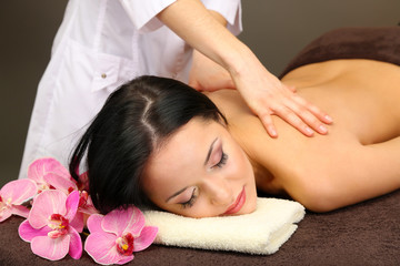 Fototapeta na wymiar Beautiful young woman in spa salon getting massage with spa