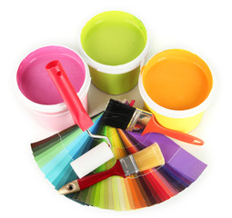 Paint pots, paintbrushes and coloured swatches isolated on