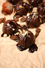 Chocolate candies and coffee beans, on beige paper background