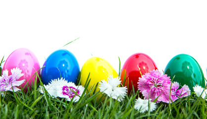 Fototapeta na wymiar Easter eggs on green grass over white background