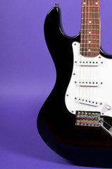 Naklejka premium Electric guitar on purple background