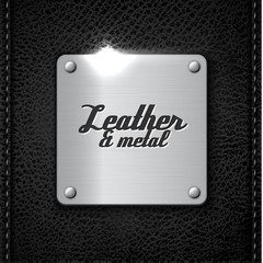 Metal badge on leather background