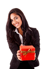 Beautiful mix race woman holding a gift over white background