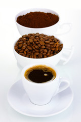 Different types of coffee in three cups isolated on white