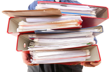 Male office worker carrying a stack of files