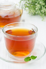 Glass cup of black tea with mint closeup