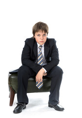 Young boy sitting on chair