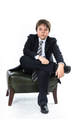 Young boy sitting on chair