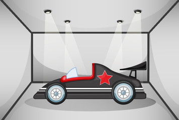 A black luxury car inside a garage