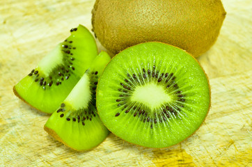 Whole kiwi fruit and his sliced segments isolated on white backg