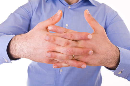 Young businessman crossing his hands.