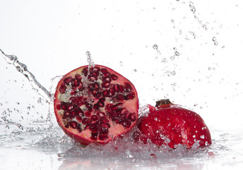 Juicy pomegranate with splashing water