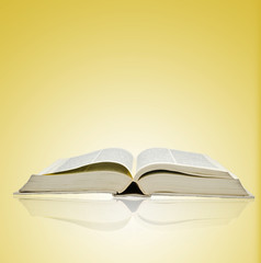 Open book on yellow background