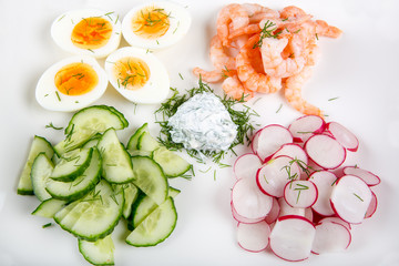 salad with eggs, cucumber, radishes and shripms