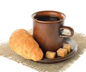 Croissant and cup of coffee on a white background