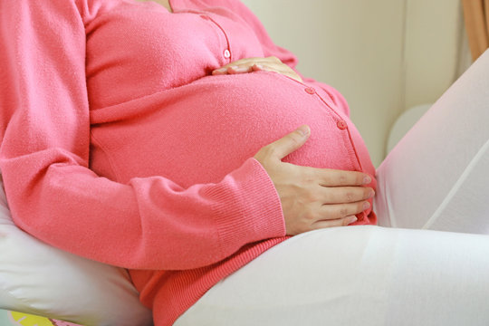 pregnant woman sitting relax on bed