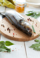 raw fish and spices on a cutting board, perch