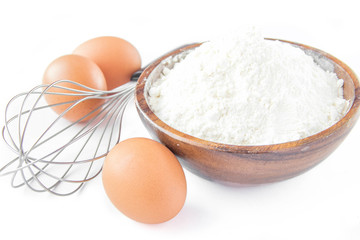 Ingredients for cooking pancakes: eggs, flour and whisk