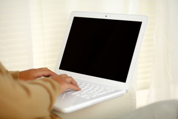 Fototapeta premium Young woman working on laptop computer