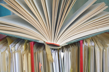 opened book and file folders,close up,bureaucracy concept