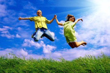 Fun couple in jump on the outdoor background