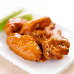 plate of buffalo wings with celery.