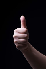 Thumb up on black background