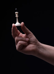 Chess in hand on a black background