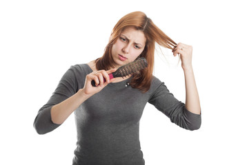 pretty girl with regret looking at the comb